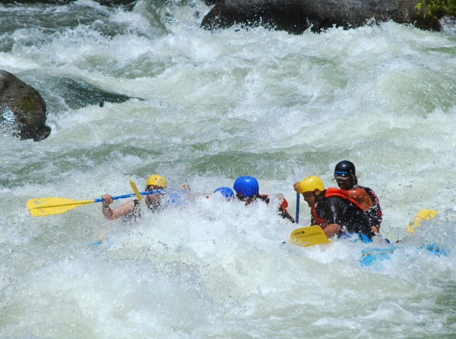 Intense white water rapids engulfing a raft with several passengers on the Kern River. Link to Fun Things to Do on page