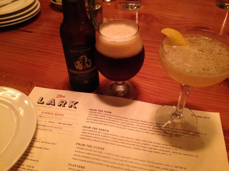 A cocktail, beer glass and bottle on a The Lark restaurant menu. Link to Where to Eat on page