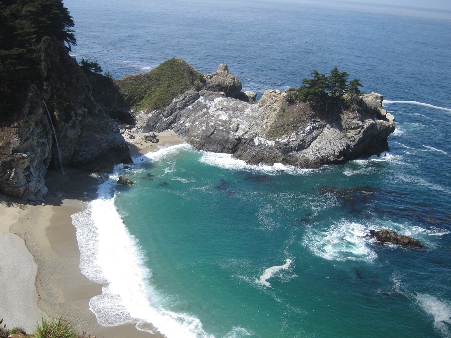 Elevated view of McWay waterfall from a cliff over a sandy beach in Big Sur. Link to the Big Sur page.