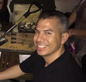 The author, Kevin, sitting and smiling in front of an elaborate pirate treasure dessert tray in a Los Angeles restaurant.