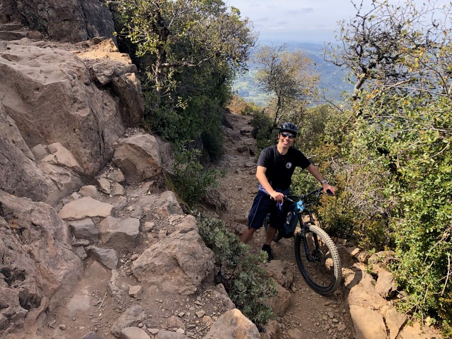 The author, Kevin, standing with his mountain bike on a rocky hilltop trail on Mount Tamalpais in Mill Valley.