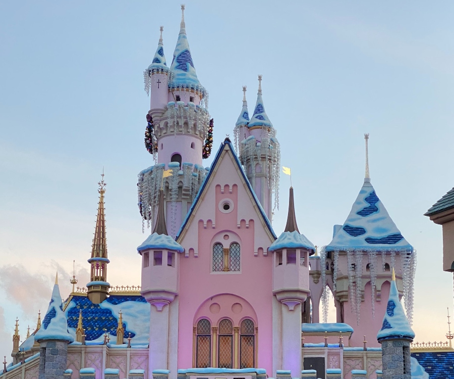 The backside of Disneyland Sleeping Beauty pink and blue castle with Christmas decor. Link to Southern California on page.