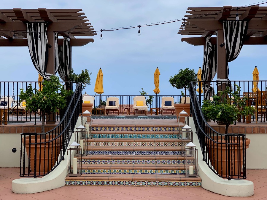 Steps with mission decorative tiles and candles leading to the hotel pool in Santa Barbara. Link to Where to Stay on page.