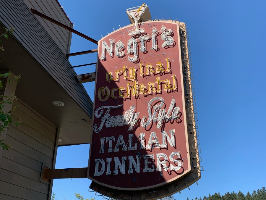 Vintage unlit neon sign of Negri's Original Occidental Family Style Italian Dinners in daylight and blue sky.