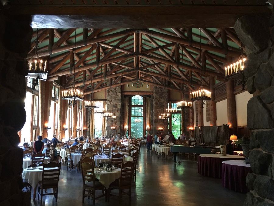 Grand dining hall with lit candles and wooden beams at the Ahwahnee hotel in Yosemite Valley